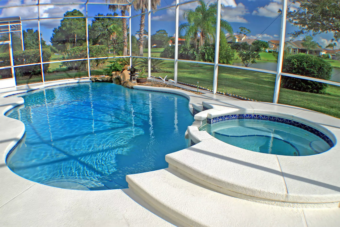 A pool and spa with a white modern deck in pristine condition